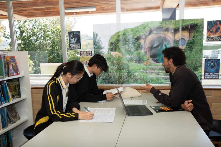 Teacher helping students