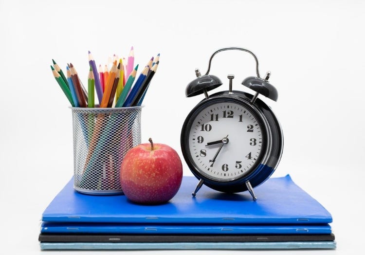 pencils, clock apple and books
